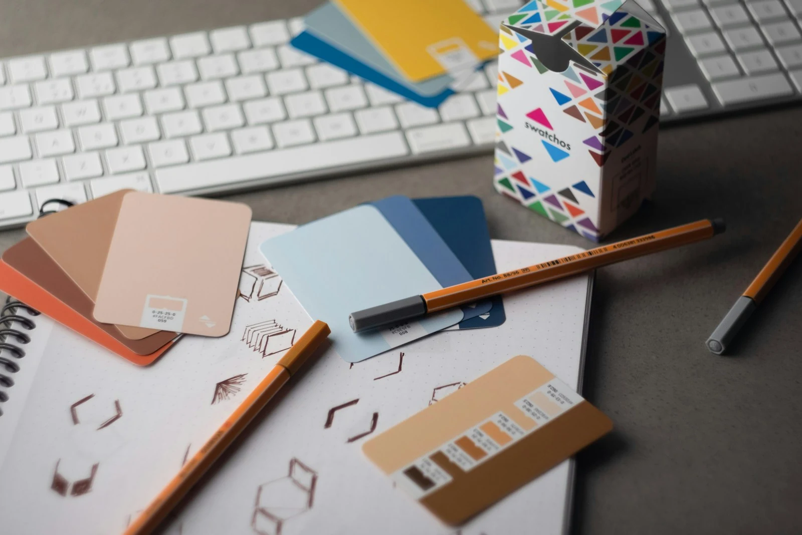 Color samples, pencils, and design materials on a creative desk